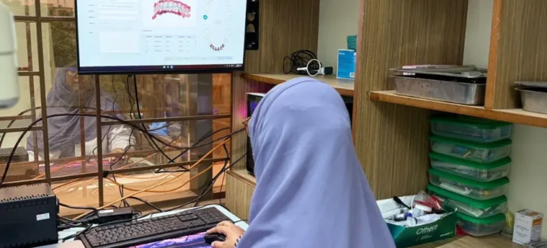 Dr. Tasmia reviewing digital dental scan and smile design software on computer in clinic